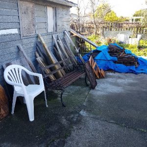 messy parking area beside garage